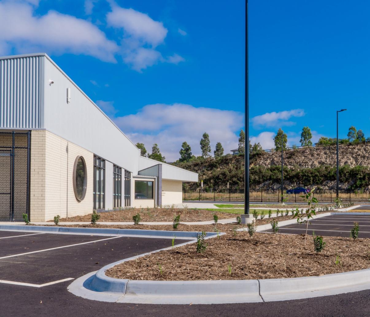 Carpark embankment planting alongside a circular window at Mernda Hills