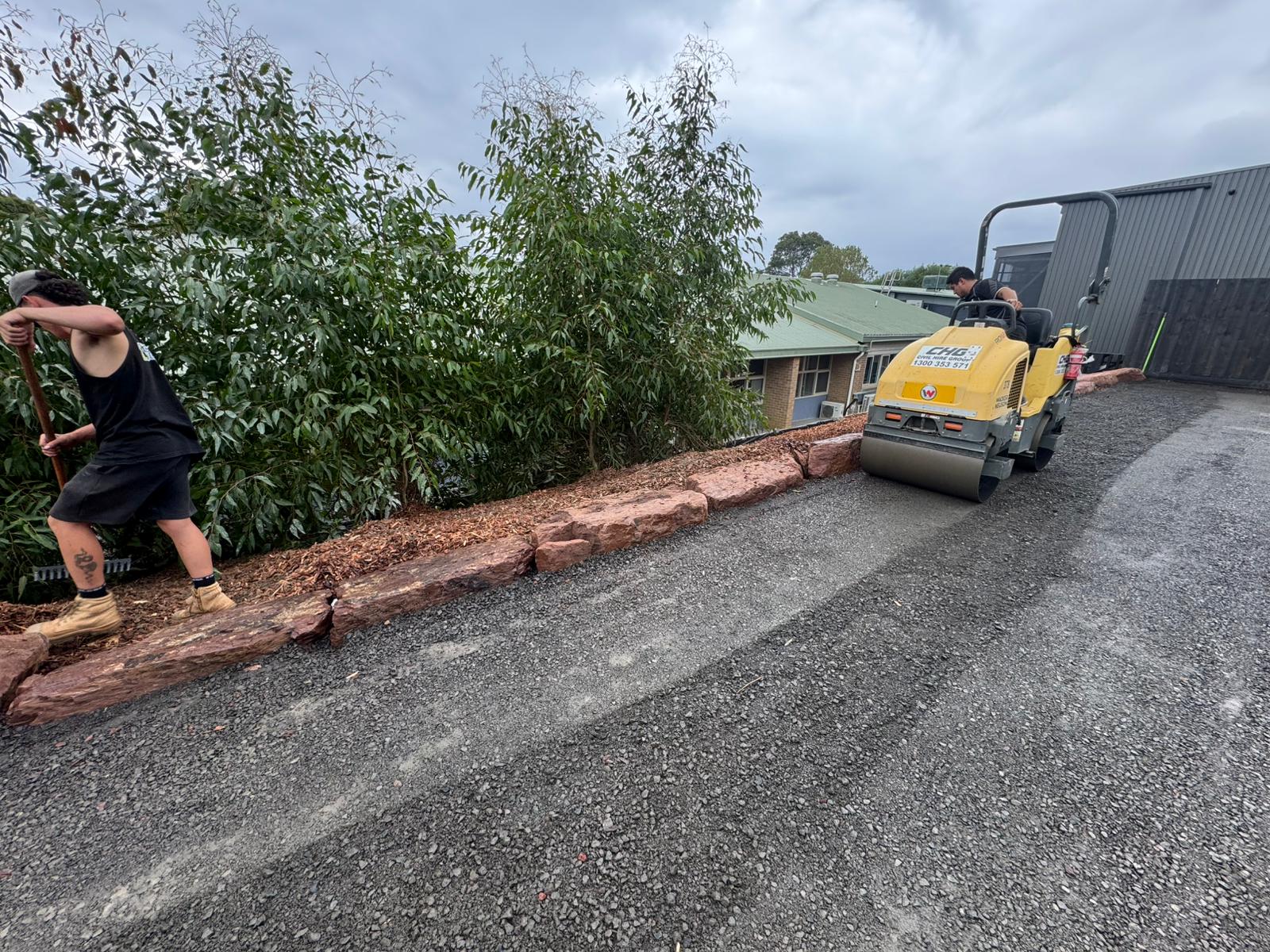Roller compacting a graded driveway base at St James Vermont