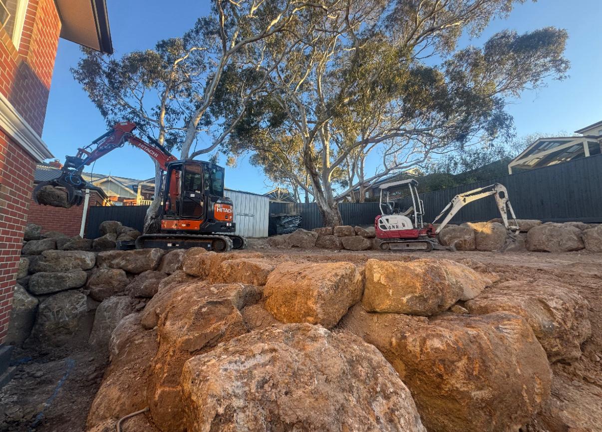 ANKS team building a boulder retaining wall during the Sunbury estate construction