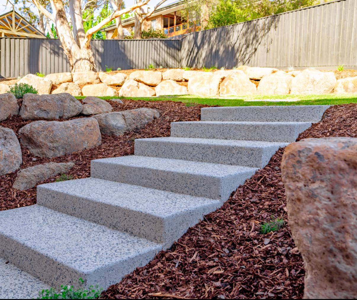 Stone steps and boulder retaining at a finished Sunbury landscape