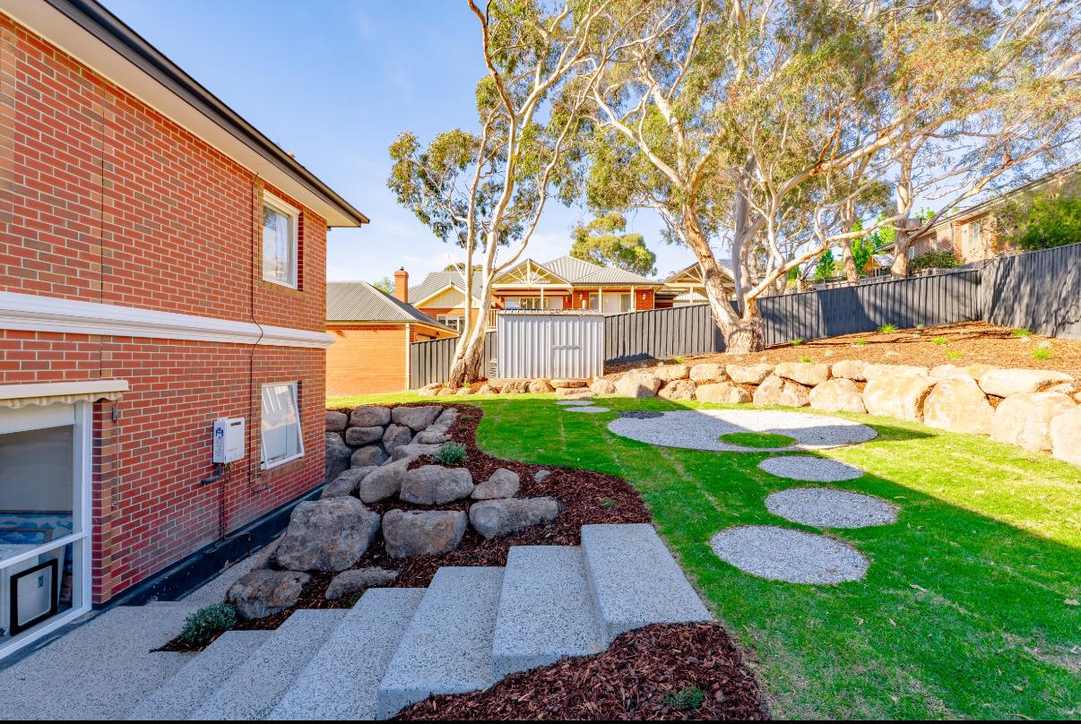Circular paver path winding through finished lawn at a Sunbury estate