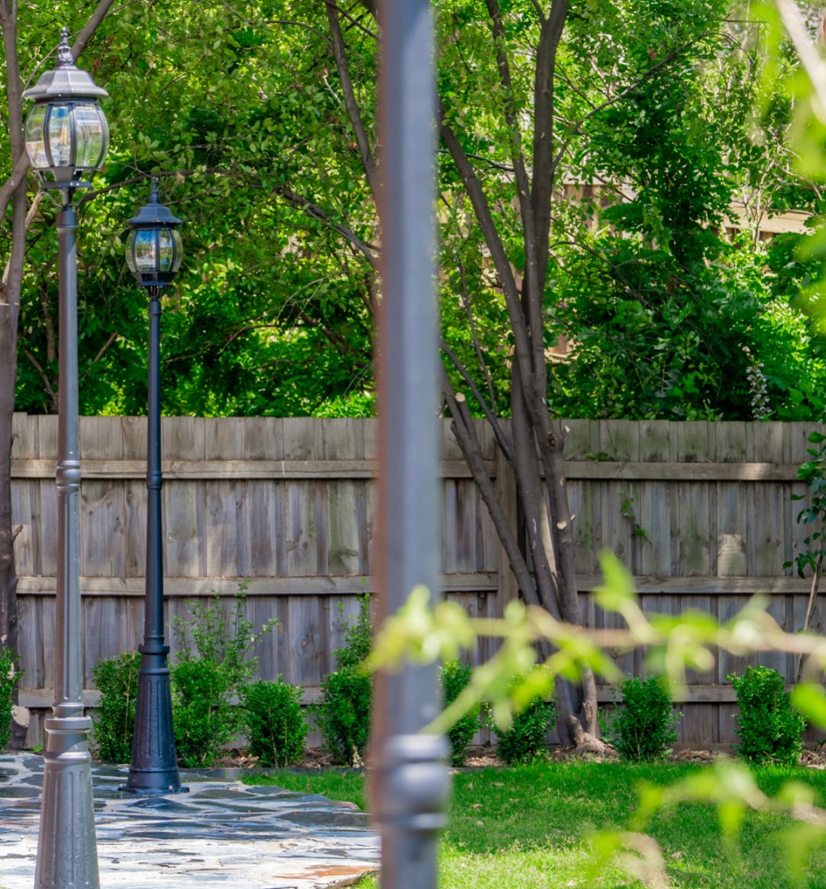 Bluestone path lined with established planting and Victorian lamp posts