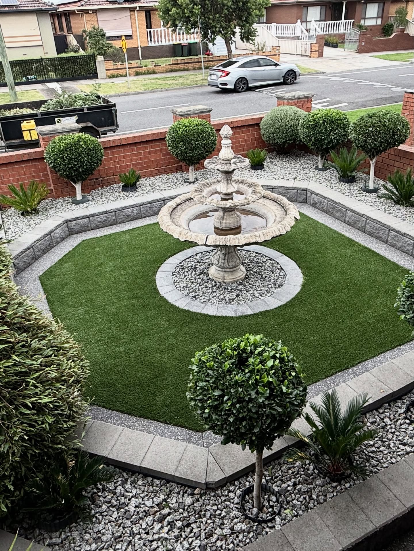 Architectural courtyard garden with central water feature and layered planting