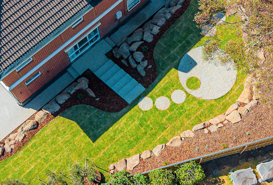 Aerial view of a stepping stone courtyard with retaining and lawn